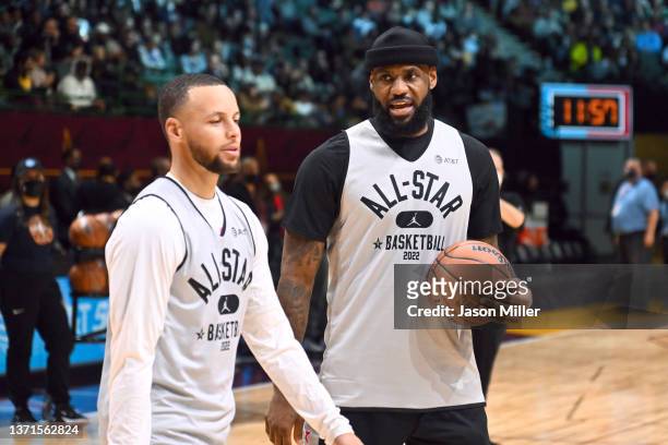 LeBron James talks with Stephen Curry of Team LeBron during the NBA All-Star practice at the Wolstein Center on February 19, 2022 in Cleveland, Ohio....
