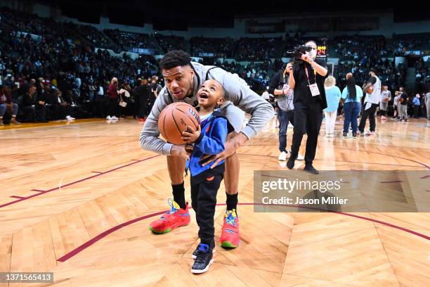 Giannis Antetokoumpo of Team LeBron lifts a young fan during the NBA All-Star practice at the Wolstein Center on February 19, 2022 in Cleveland,...