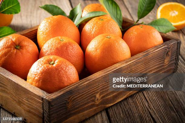 orange fruits wooden crate box in harvest with orange tree leaves fresh - orange stock pictures, royalty-free photos & images