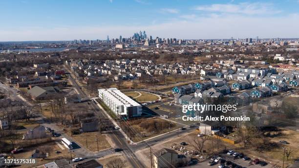 residentia zone of camden, new jersey, with a remote view of downtown philadelphia skyline in the backdrop. - new jersey skyline stock pictures, royalty-free photos & images