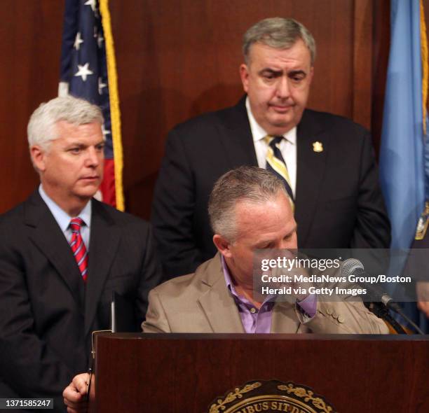 Suffolk County District Attorney Dan Conley, left, and Boston Police Commissioner Ed Davis, right, listen as Casey Sherman, whose aunt, Mary...