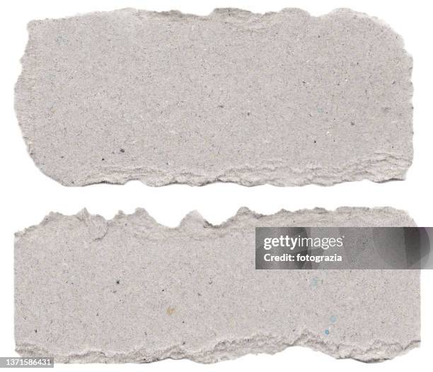 pieces of gray torn cardboard isolated on white - torn ストックフォトと画像