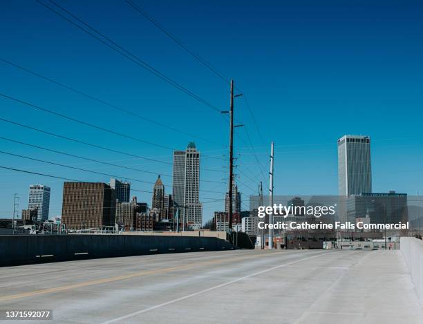 view of downtown tulsa set against a clear blue sky - tulsa v oklahoma stock pictures, royalty-free photos & images