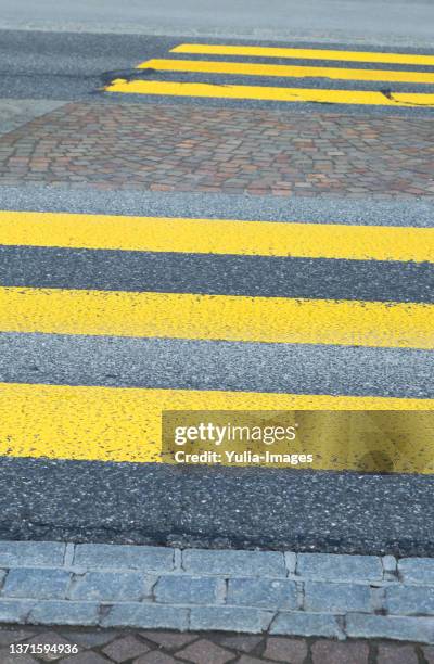 yellow painted zebra crossing markings on a road - pedestrian walkway stock-fotos und bilder