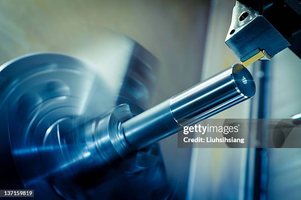 close-up of a blue and gray-toned cnc lathe processing - cnc stock pictures, royalty-free photos & images