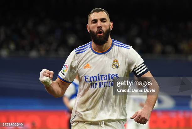 Karim Benzema of Real Madrid celebrates after scoring their team's third goal from the penalty spot during the LaLiga Santander match between Real...