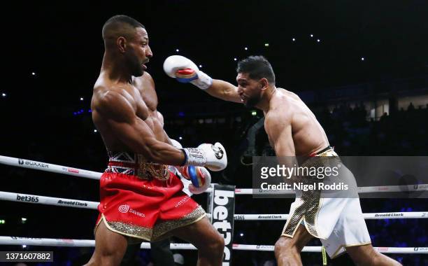 Amir Khan punches Kell Brook during their Welterweight contest at AO Arena on February 19, 2022 in Manchester, England.