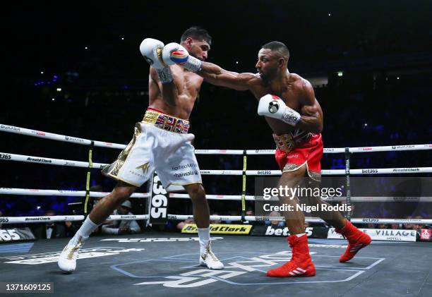 Kell Brook punches Amir Khan during their Welterweight contest at AO Arena on February 19, 2022 in Manchester, England.