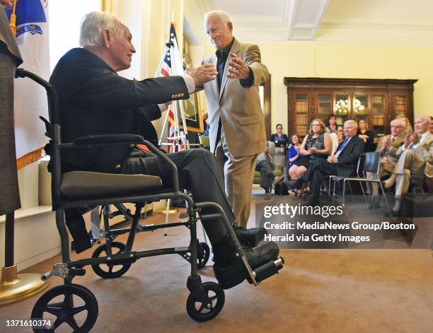 Former Attorney General Francis X. Bellotti gives an embrace to Robert Crane, former Treasurer and Receiver-General of Massachusetts on Tuesday,June...