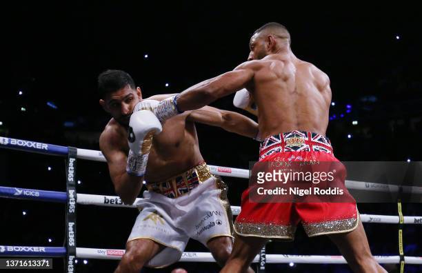 Kell Brook punches Amir Khan during their Welterweight contest at AO Arena on February 19, 2022 in Manchester, England.