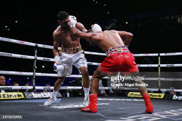 Kell Brook punches Amir Khan during their Welterweight contest at AO Arena on February 19, 2022 in Manchester, England.