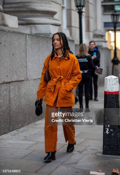 Guest is seen wearing suede belted button shirt and pant in brown outside Rixo during London Fashion Week February 2022 on February 18, 2022 in...