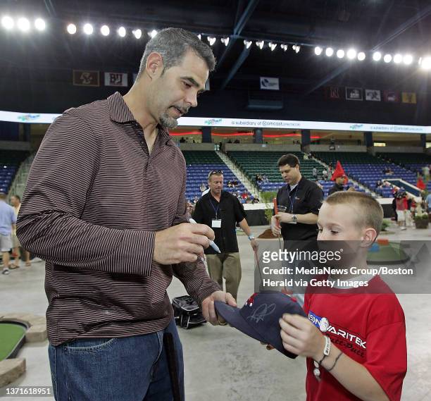 Red Sox Mike Lowell signs for Mithchell Andrea, 10 of Tewkbury, at the Celebrity Putt Putt for charity at Tsongas Memorial arena in Lowell. Thursday,...