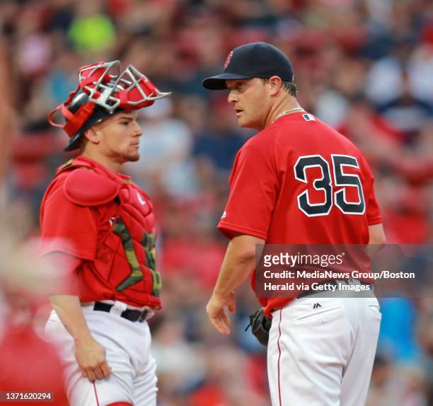 Boston Red Sox starting pitcher Steven Wright and Boston Red Sox catcher Christian Vazquez talk in the first at the Red Sox take on the Angles at...
