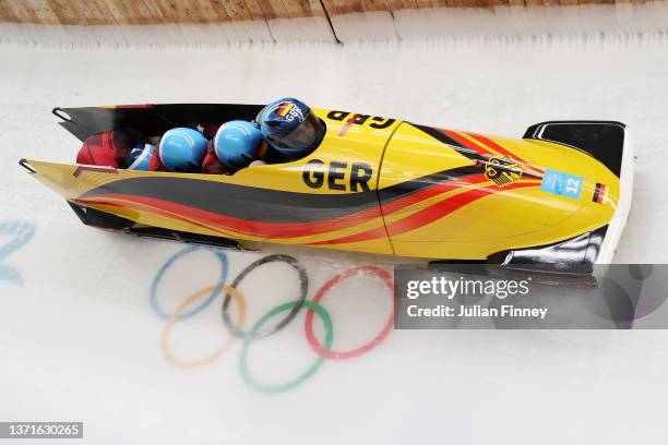 Christoph Hafer, Matthias Sommer, Michael Salzer and Tobias Schneider of Team Germany slide during the four-man Bobsleigh heat 3 on day 16 of Beijing...