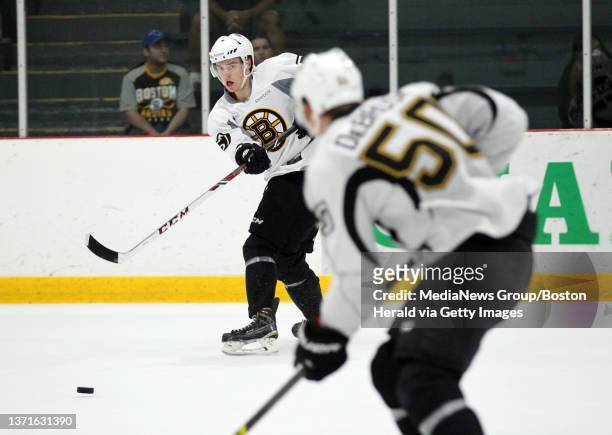 Jakob Forsbacka-Karlsson passes the puck to Jake DeBrusk during Bruins development camp at Ristuccia Arena. Tuesday, July 14, 2015. Staff photo by...