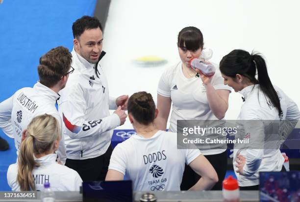 Coaches Kristian Lindstrom of Great Britain and David Murdoch talk with their team during the Women's Gold Medal match between Team Japan and Team...