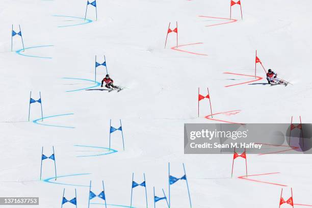 Fabian Wilkens Solheim of Team Norway and Tommy Ford of Team United States ski during the Mixed Team Parallel Small Final on day 16 of the Beijing...