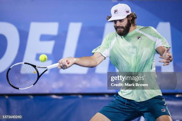 Reilly Opelka of the United States returns a shot against John Millman of Australia during the Semifinals of the Delray Beach Open by Vitacost.com at...
