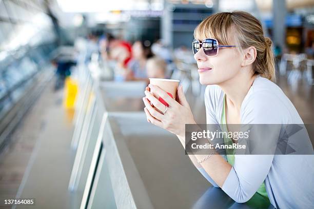 young woman in airport café - airport shopping stockfoto's en -beelden