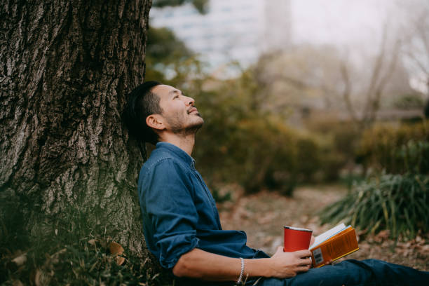 man having a coffee break at park in city, tokyo - take breaks stock pictures, royalty-free photos & images