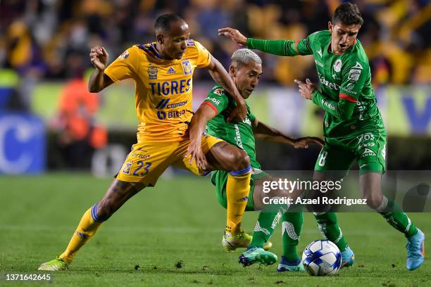Luis Quiñones of Tigres fights for the ball with Ricardo Chávez and Juan Sanabria of San Luis during the 6th round match between Tigres UANL and...