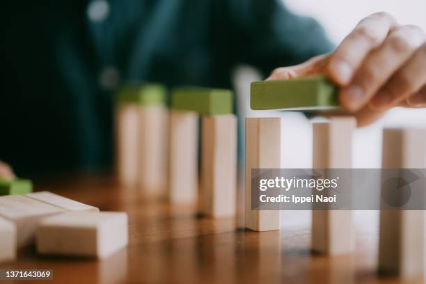 building bridge with wooden toy blocks on table - asian games day 1 stock-fotos und bilder