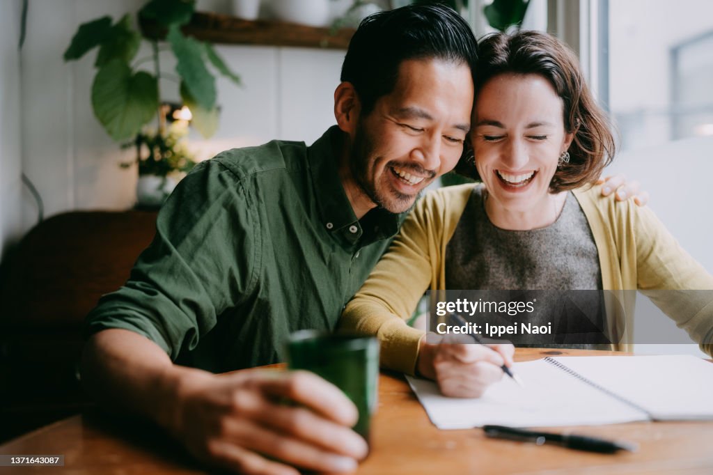 Cheerful couple planning their future home