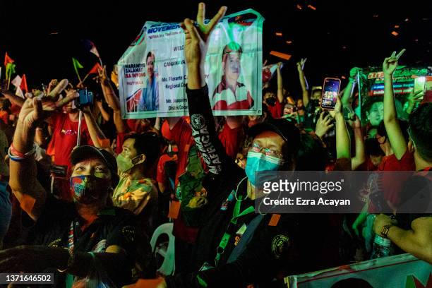 Supporters cheer as Ferdinand "Bongbong" Marcos Jr., the son of the late dictator Ferdinand Marcos, and Davao city Mayor Sara Duterte, daughter of...
