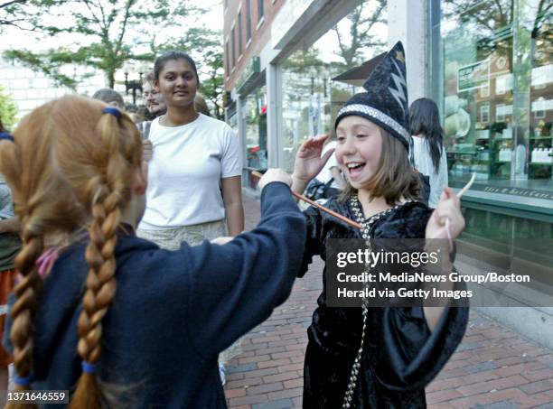 Cambridge, MA. Harry Potter fans Lola Dement Myers right, and Kira Peterson left, both of Watertown act out scenes from the movie as they wait on...
