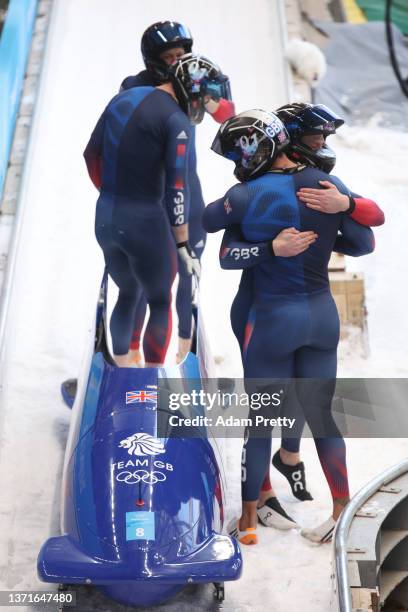 Brad Hall, Taylor Lawrence, Nick Gleeson and Greg Cackett of Team Great Britain react to their slide during the four-man Bobsleigh heat 4 on day 16...