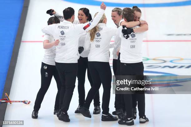 Hailey Duff, Coach David Murdoch, Eve Muirhead, Milli Smith, Vicky Wright, Kristian Lindstrom and Jennifer Dodds of Team Great Britain celebrate with...