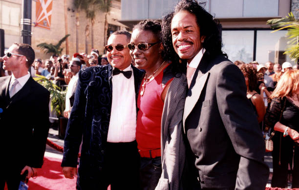 Singers and musicians Ralph Johnson, Philip Bailey and Verdine White of Earth, Wind & Fire poses for photos on the red carpet outside the Kodak...