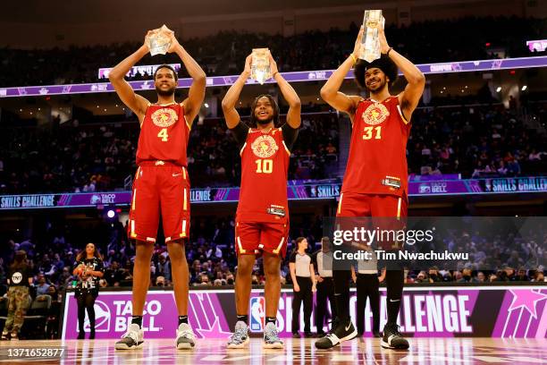 Evan Mobley, Darius Garland and Jarrett Allen of Team Cavs hold up their trophies after winning the Taco Bell Skills Challenge as part of the 2022...