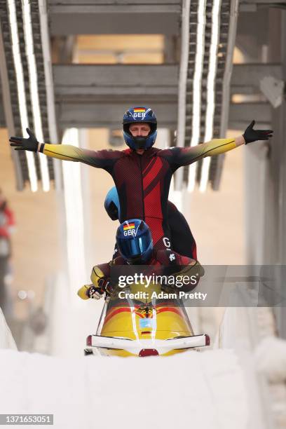 Francesco Friedrich, Thorsten Margis, Candy Bauer and Alexander Schueller of Team Germany celebrate winning gold in the four-man Bobsleigh heat 4 on...