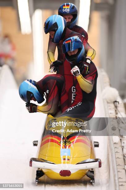 Francesco Friedrich, Thorsten Margis, Candy Bauer and Alexander Schueller of Team Germany celebrate winning gold in the four-man Bobsleigh heat 4 on...