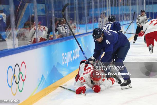 Mikko Lehtonen of Team Finland knocks Vadim Shipachyov of Team ROC to the ice in the second period during the Men's Ice Hockey Gold Medal match...
