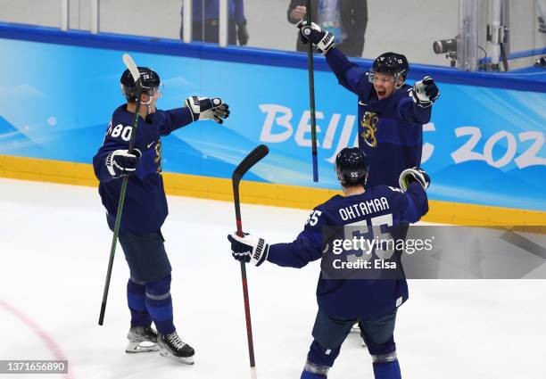 Ville Pokka of Team Finland celebrates his goal with Saku Maenalanen and Atte Ohtamaa in the second period during the Men's Ice Hockey Gold Medal...