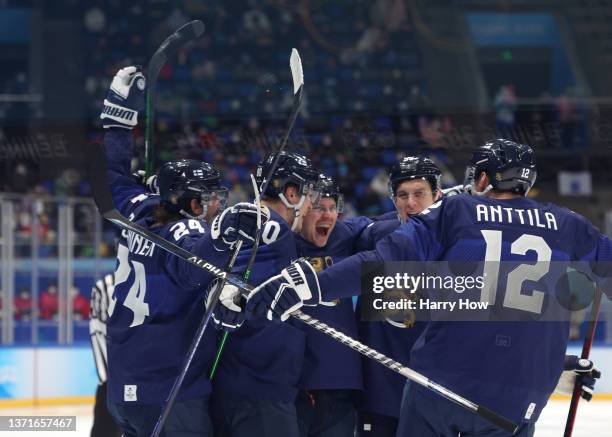 Ville Pokka of Team Finland celebrates with teammates after his goal in the second period during the Men's Ice Hockey Gold Medal match between Team...