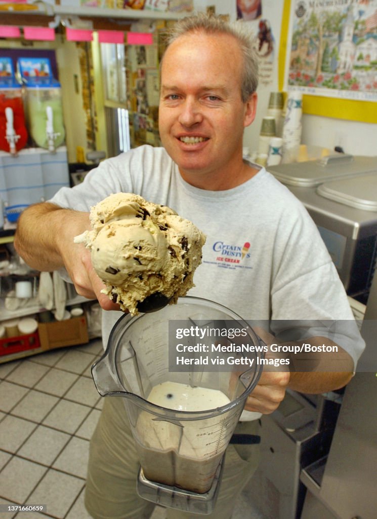 (6/22/06 MANCHESTER BY THE SEA,MA) (filename) THE HERALD SAMPLES THE FRAPPES AT CAPTAIN DUSTYS. Owner John Barrlett displays a scoup of White Russian Chip ice cream that makes the body of ""The Mojo Frappe"" inside the store. Other ingredients are Cho