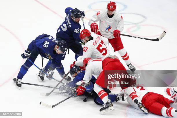 Valtteri Filppula of Team Finland is on the ice as Dmitri Voronkov and Alexander Nikishin of Team ROC fall in the third period during the Men's Ice...