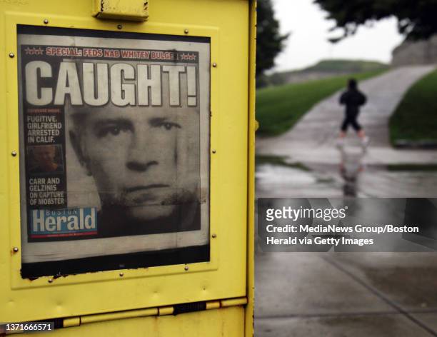 The early morning scene at Southie's Castle Island shows a newspaper today, June 23 announcing the capture of James Whitey Bulger. Staff photo by...