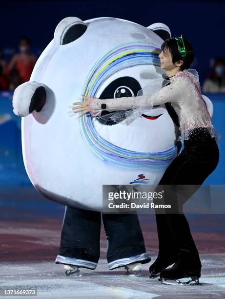 Yuzuru Hanyu of Team Japan hugs mascot Bing Dwen Dwen following the Figure Skating Gala Exhibition on day sixteen of the Beijing 2022 Winter Olympic...