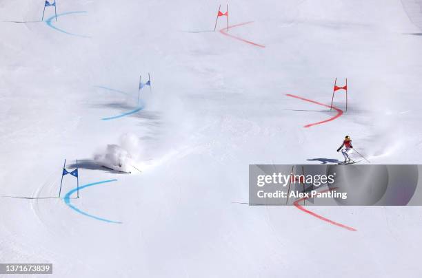 Paula Moltzan of Team United States falls just before Emma Aicher of Team Germany straddles a gate during the Mixed Team Parallel 1/2 Finals on day...
