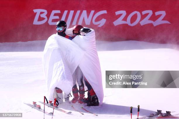 Tommy Ford of Team United States , Mikaela Shiffrin of Team United States , and Paula Moltzan of Team United States look on following the Mixed Team...