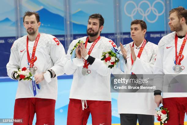 Anton Slepyshev of Team ROC, Vyacheslav Voinov, Alexander Samonov and Vladimir Tkachev of Team ROC look on during the medal ceremony after the Men's...