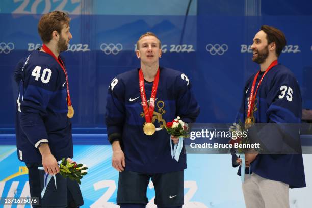 Petteri Lindbohm, Juuso Hietanen and Frans Tuohimaa of Team Finland look on during the medal ceremony after the Men's Ice Hockey Gold Medal match...