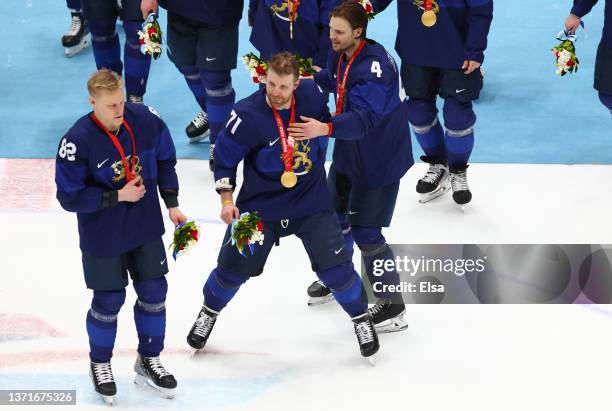 Harri Pesonen, Leo Komarov and Mikko Lehtonen of Team Finland skate to center ice for the group photo during the medal ceremony after the Men's Ice...