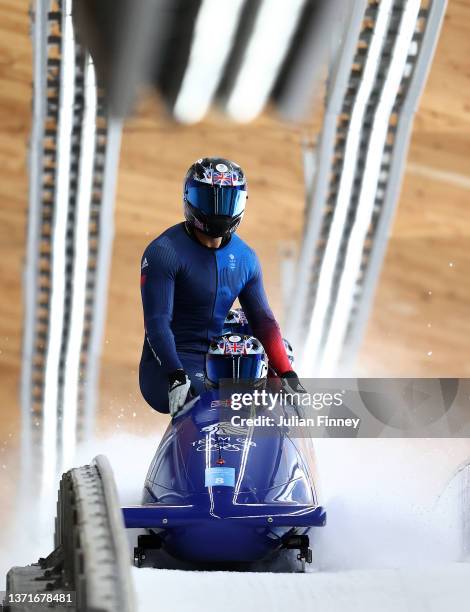 Brad Hall, Taylor Lawrence, Nick Gleeson and Greg Cackett of Team Great Britain react to their slide during the four-man Bobsleigh heat 4 on day 16...