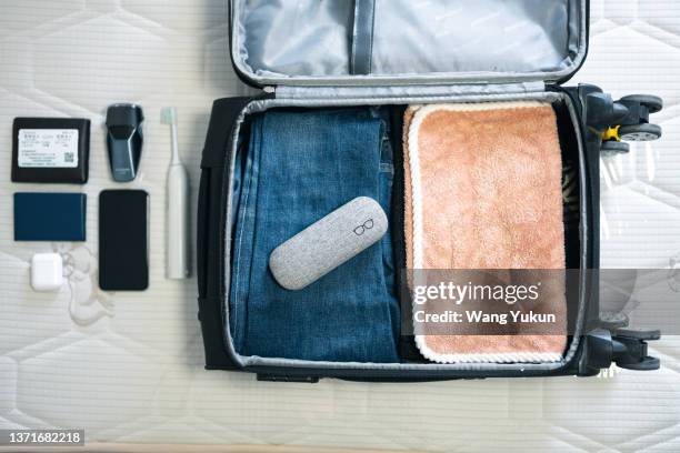 top view of packing suitcase - open suitcase stock pictures, royalty-free photos & images